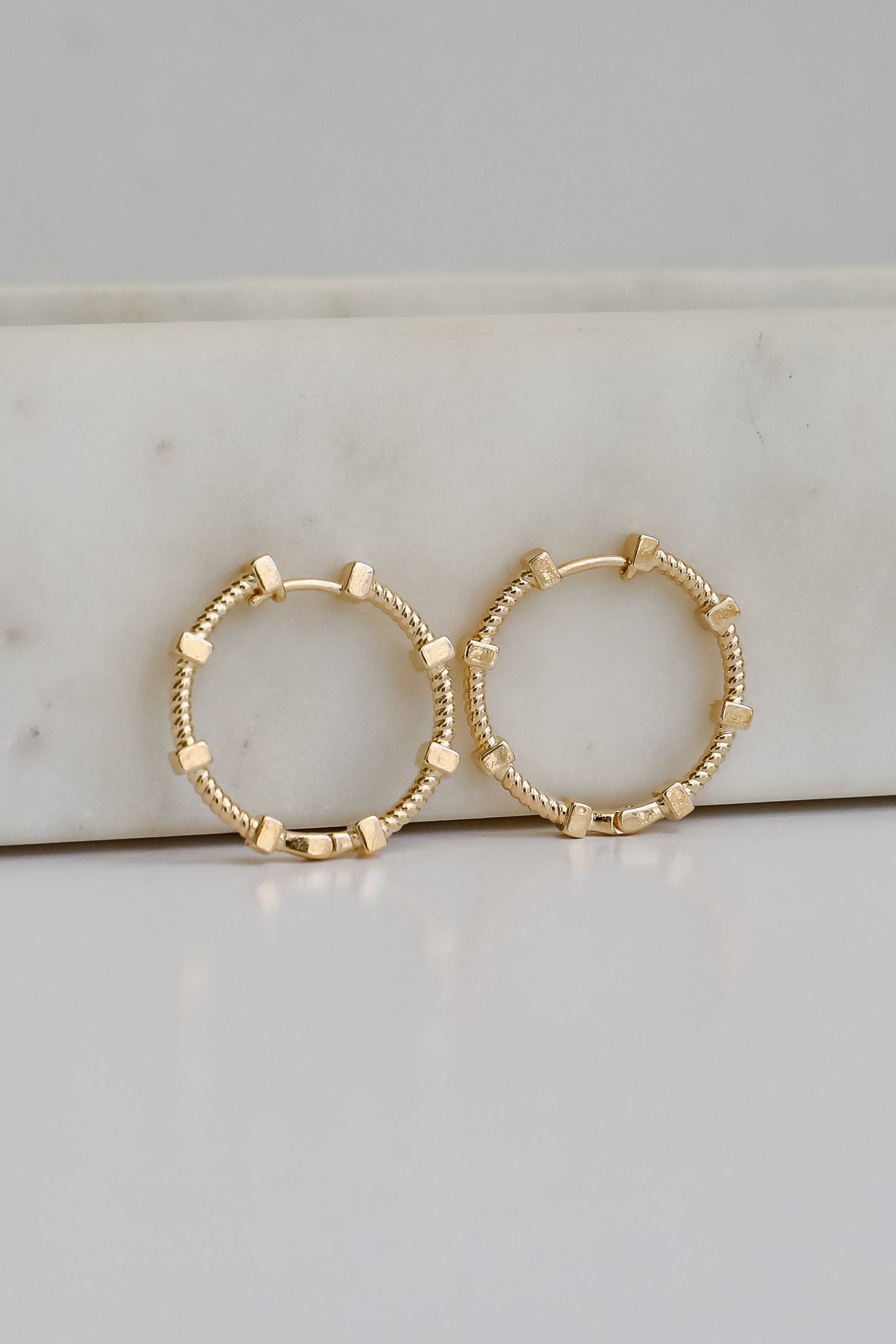 shopdressup_gold_textured_hoop_earrings-5_26c25072-c41a-44d2-bbf0-95ff27653139.jpg